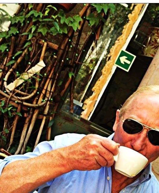 Keith Bulfin drinking coffee at a cafe in Mexico City, a historical photograph